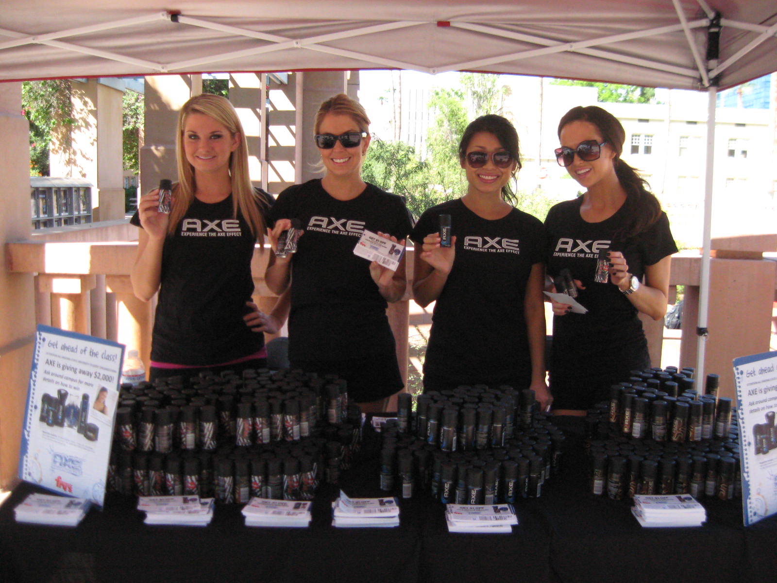 Four women wearing black posing with products