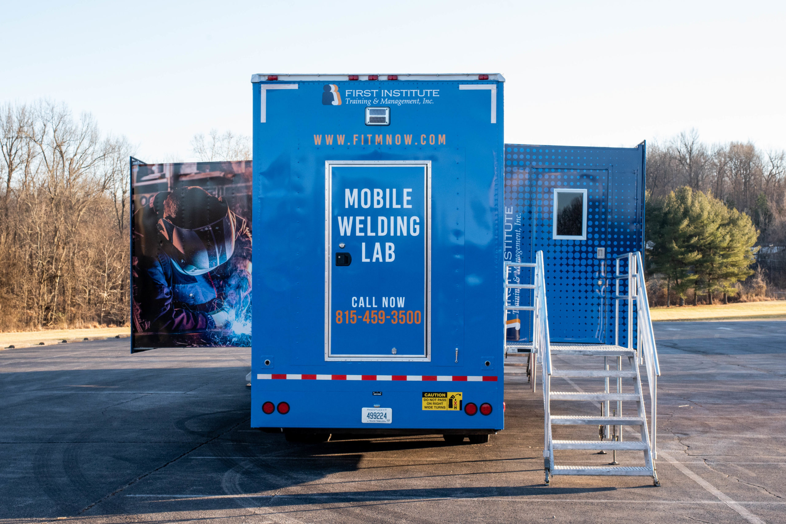 First Institute Rear of mobile trailer with Slide Outs Deployed and Stairs 3