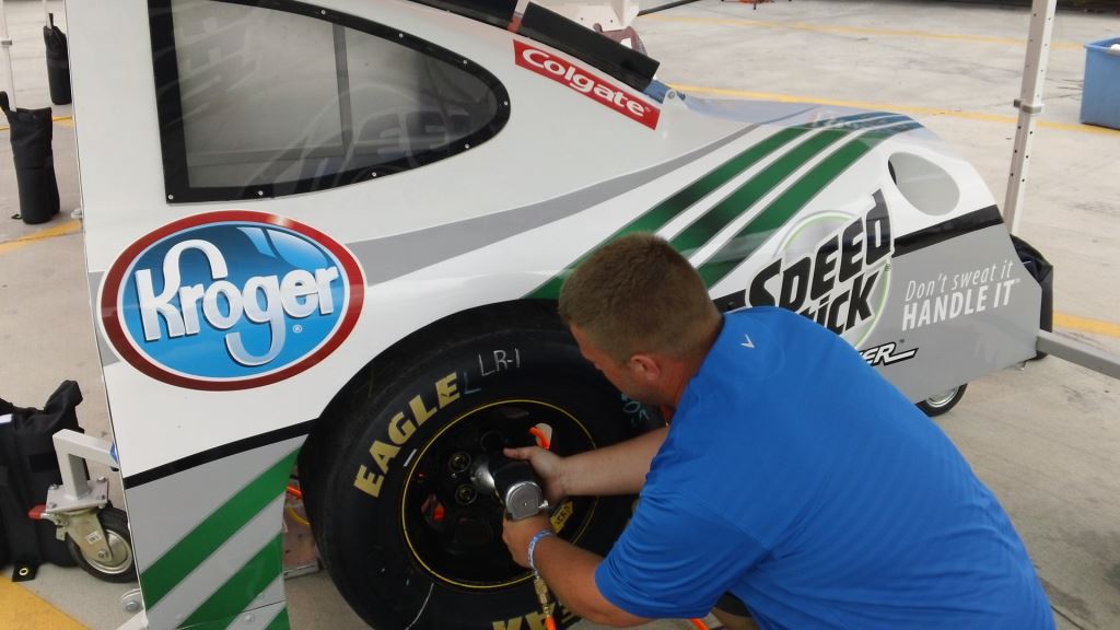 Man fixing a race car tyre