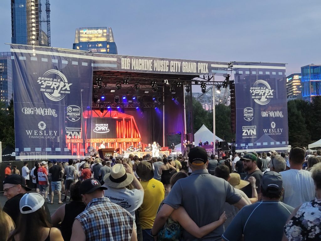 People gathered in front a mobile stage